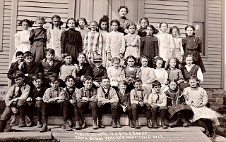 4 & 5th Grades 1910. Maud Legler is the shorter girl in the dark dress standing 4th from right in the third row from front.  The teacher is Miss Edyth Blum.  Her name is wrong on this photo.